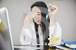 Young business woman person sleepy and has frustration eye problems with cephalalgia disease from using laptop computer on her