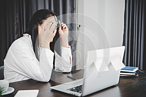 Young business woman person sleepy and has frustration eye problems with cephalalgia disease from using laptop computer on her