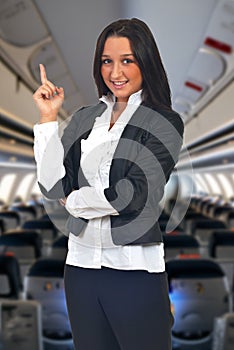 Young business woman pointing up