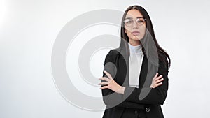 Young business woman posing with crossed hands isolated on white. Medium shot on RED camera