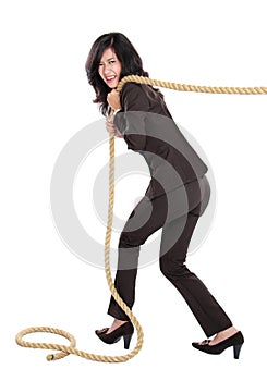 Young business woman pulling a rope