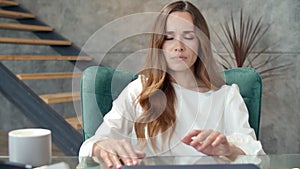 Young business woman relaxing on chair at home office. Tired girl taking break