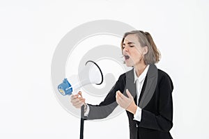 Young business woman is shouting through a megaphone