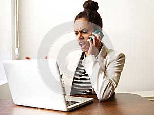 Young business woman shouting on the phone