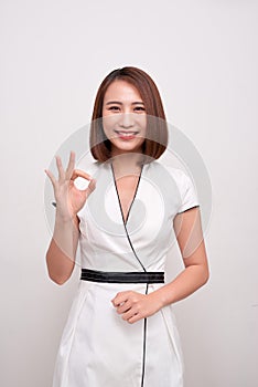 Young business woman showing OK hand sign