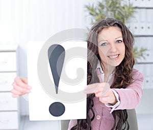 Young business woman showing poster with an exclamation point .