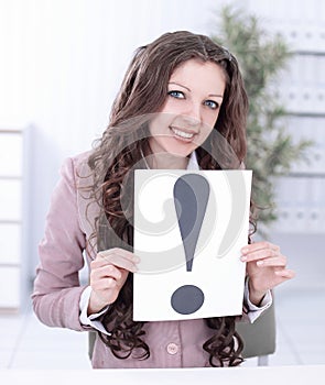 Young business woman showing poster with an exclamation point .