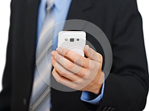 Young business woman showing white mobile phone