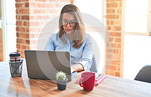 Young business woman sitting at desk working using computer laptop, modern executive girl at the office