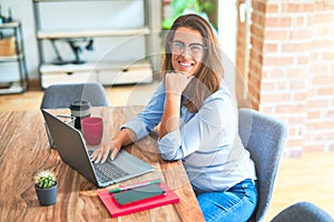 Young business woman sitting at desk working using computer laptop, modern executive girl at the office