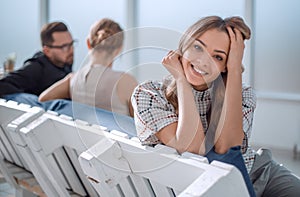 young business woman sitting in office lobby at coffee break