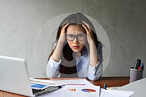 Young business woman sitting in the office with many documents, Stressful for work.