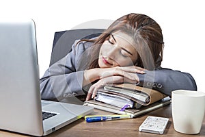 Young business woman sleeping at workplace