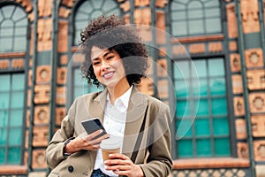 woman smiles happy with a mobile phone in the hand