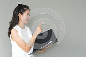 Young Business woman smiling holding document file pointing hand