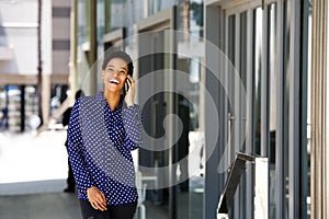 Young business woman smiling and talking on cell phone
