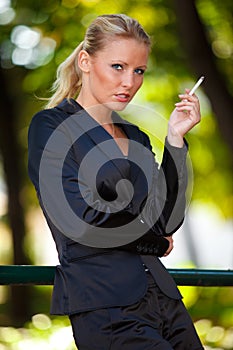 Young business woman smoking cigarette