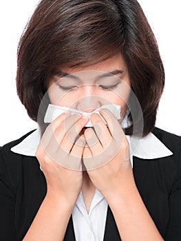 Young business woman sneezing
