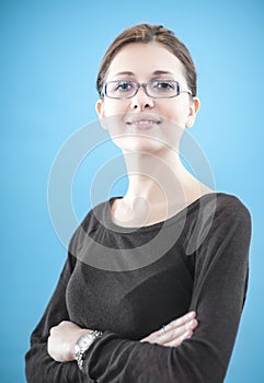 Young business woman standing with folded hands