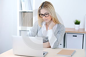 Young business woman or student girl sitting at office workplace with laptop computer. Home business concept