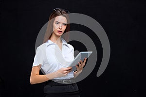 The young business woman with tablet on black background