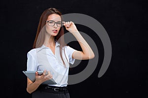 The young business woman with tablet on black background