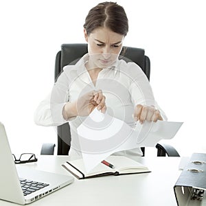 Young business woman tear paper on her desk