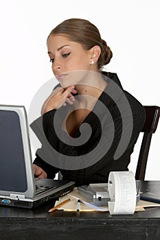 Young Business Woman in Thought at Computer