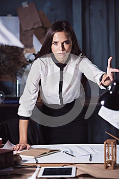 Young business woman throwing documents at camera.