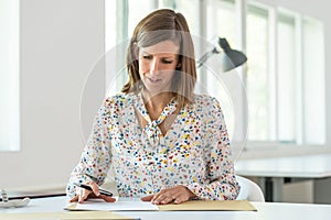 Young business woman about to sign a contract