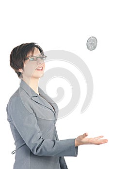 Young business woman tossing quarter dollar