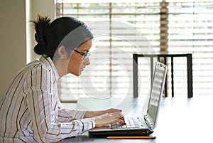 Young Business Woman Typing on Laptop