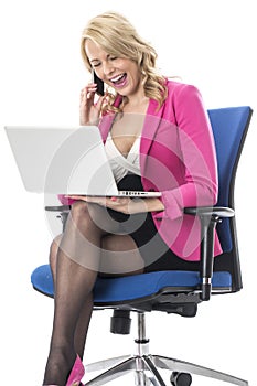 Young Business Woman Using a Laptop Computer and Mobile Cell Phone