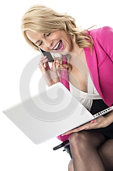 Young Business Woman Using a Laptop Computer and Mobile Cell Phone