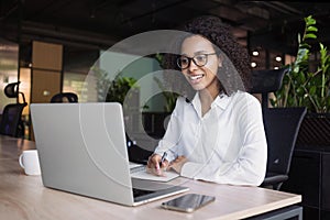 Young business woman using laptop computer at office, Student girl working at modern workspace.