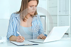 Young business woman using laptop