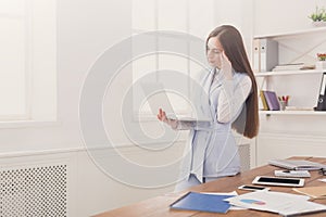 Young business woman using laptop at office