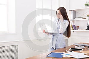 Young business woman using laptop at office