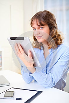 Young business woman using a tablet