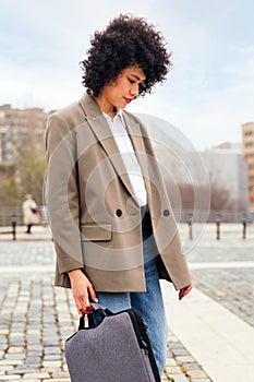 business woman walking by the city with briefcase