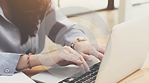 Young business woman working on laptop computer while sitting in vintage cafe