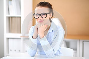 Young business woman working on laptop in office. Successful business concept.