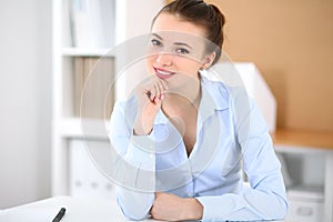 Young business woman working on laptop in office. Successful business concept.