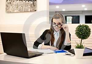 Young business woman working in the office with a laptop