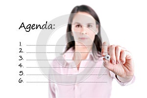 Young business woman writing blank agenda list.