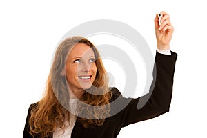 Young business woman writting with marker on a transparent board