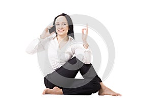 Young business woman in yoga pose talking on mobile phone on white background