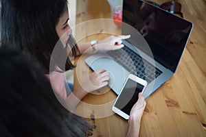 Young business women compering laptop and smartphone display, mockup