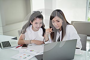 Young business women working together in office space