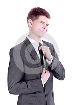 Young businessman adjusting his tie.isolated on a white